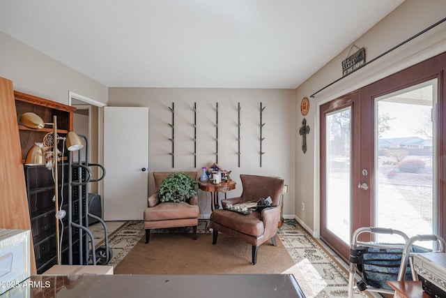 sitting room with carpet and french doors