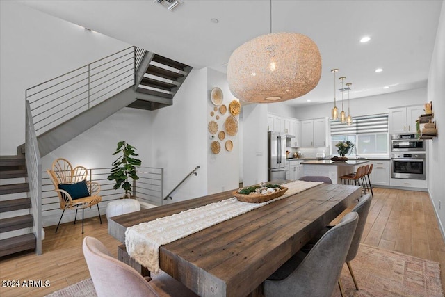 dining area with light hardwood / wood-style flooring and sink