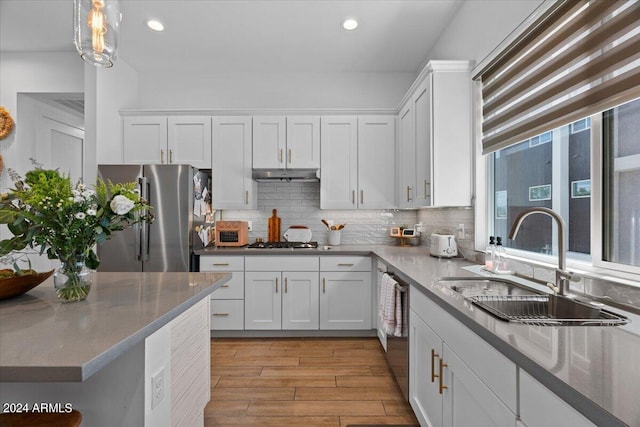 kitchen with white cabinets, appliances with stainless steel finishes, and sink