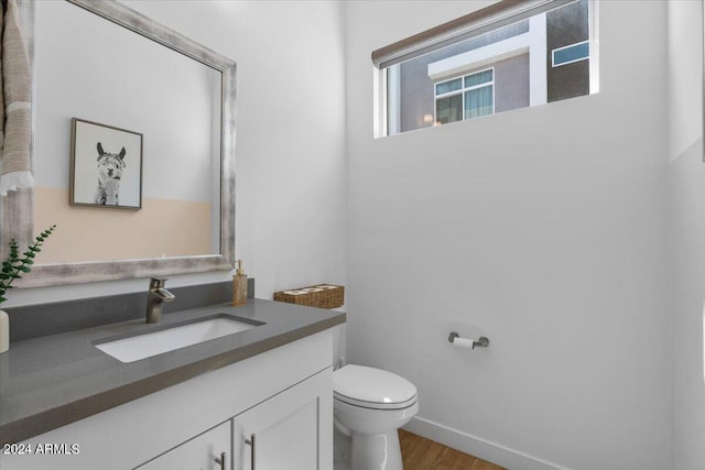 bathroom featuring hardwood / wood-style floors, vanity, and toilet