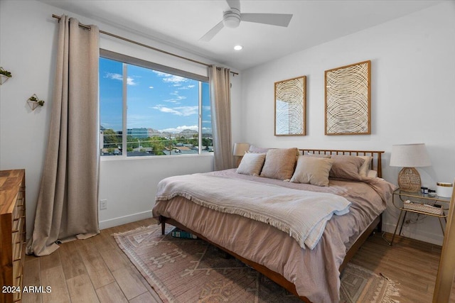 bedroom with ceiling fan and wood-type flooring