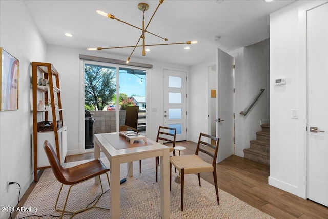 dining room with hardwood / wood-style flooring and a chandelier