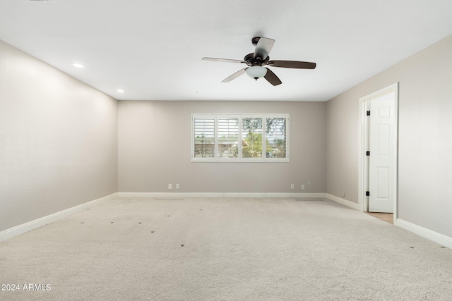 spare room featuring ceiling fan and light carpet