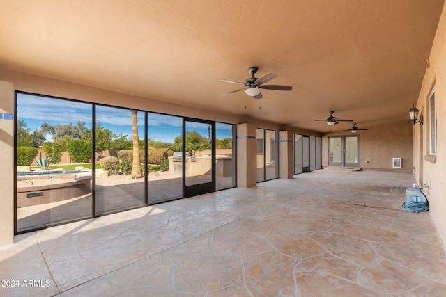 view of patio with ceiling fan and a pool