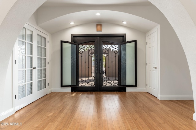 foyer featuring light hardwood / wood-style flooring and french doors