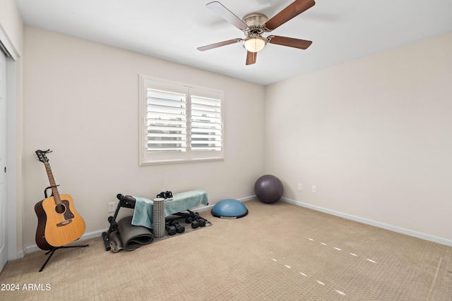 workout room with light colored carpet and ceiling fan