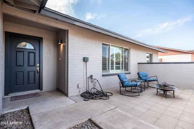 property entrance featuring a patio