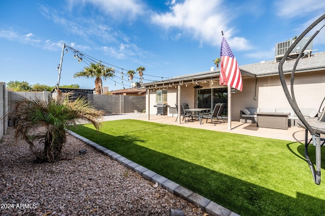 rear view of property with a yard and a patio