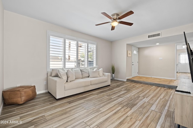 living room with ceiling fan and light wood-type flooring