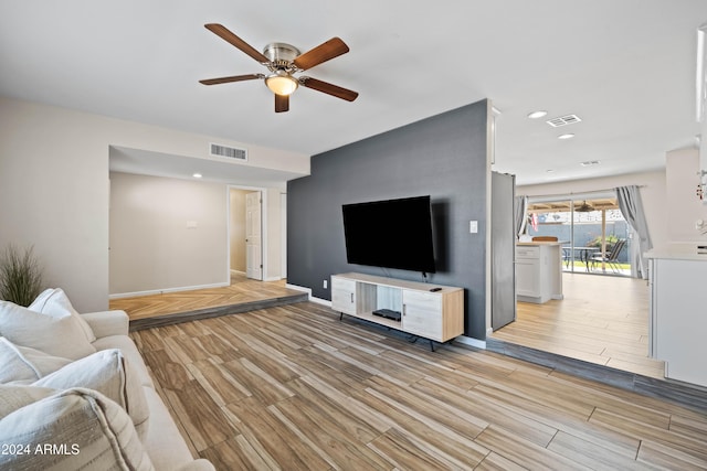 living room featuring ceiling fan and light wood-type flooring