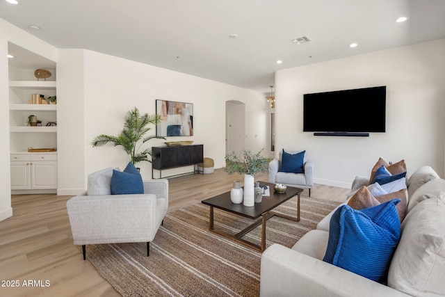 8227 E Beardsley Rd, Scottsdale, AZ 85255 - living area featuring visible vents, light wood-style flooring, recessed lighting, and arched walkways