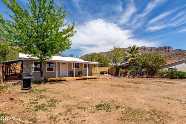 rear view of property featuring a fenced backyard and a mountain view
