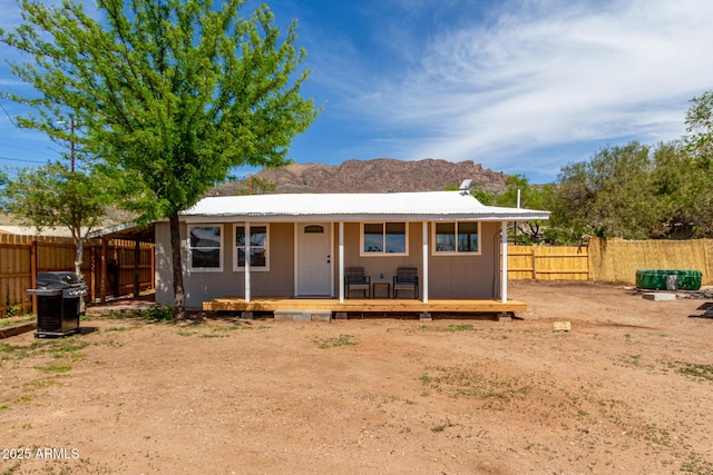 back of property featuring a fenced backyard and a mountain view