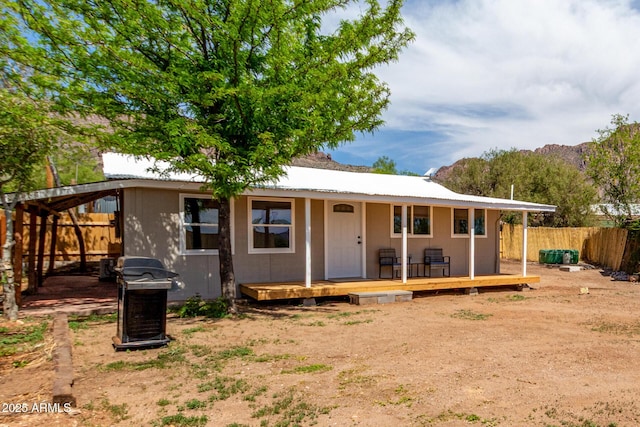 view of front of house featuring a porch and fence
