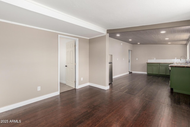 unfurnished living room featuring baseboards, recessed lighting, bar area, and dark wood-style flooring