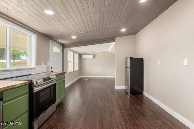 kitchen with recessed lighting, a wall unit AC, butcher block counters, green cabinets, and appliances with stainless steel finishes