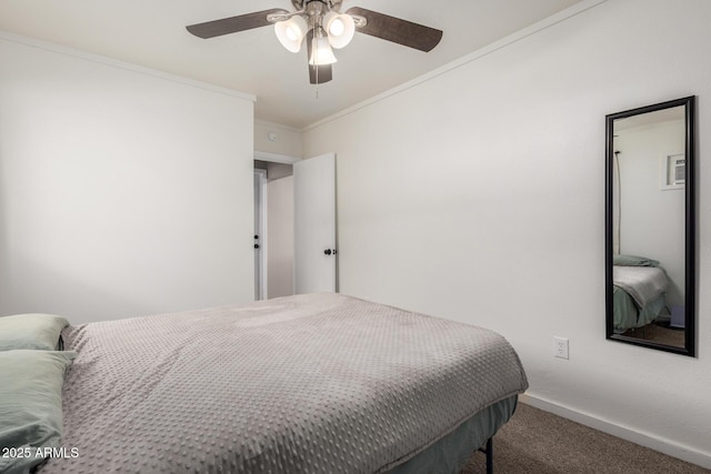 carpeted bedroom featuring crown molding, baseboards, and a ceiling fan