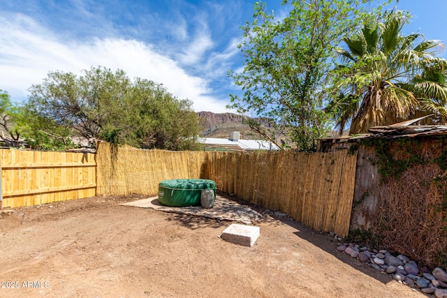 view of yard featuring a fenced backyard and a mountain view