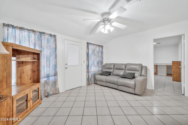 living room with light tile patterned floors, a textured ceiling, ceiling fan, and lofted ceiling