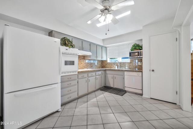 kitchen with decorative backsplash, light tile patterned floors, white appliances, and ceiling fan