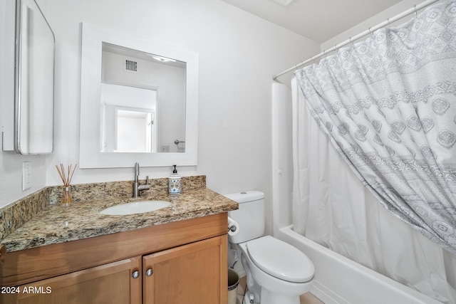 full bathroom with shower / tub combo, vanity, and toilet