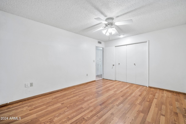 unfurnished bedroom with ceiling fan, light hardwood / wood-style floors, and a textured ceiling