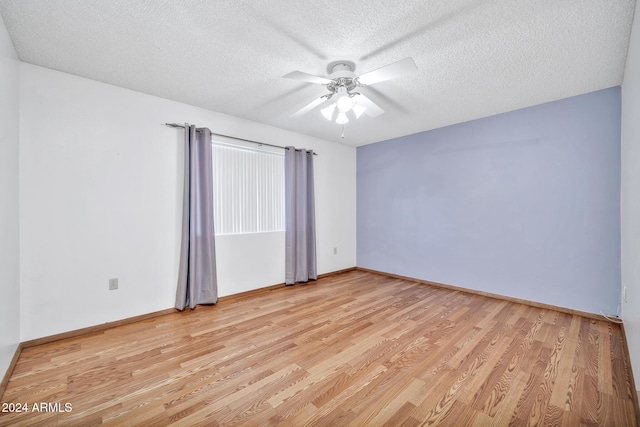 unfurnished room featuring ceiling fan, a textured ceiling, and light wood-type flooring