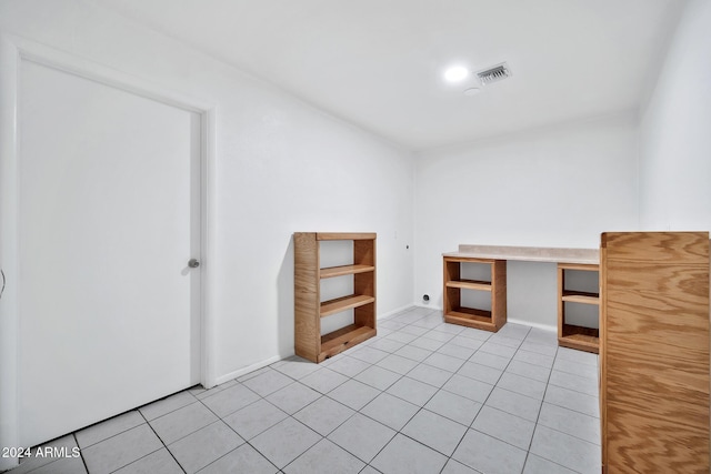 unfurnished office featuring light tile patterned flooring