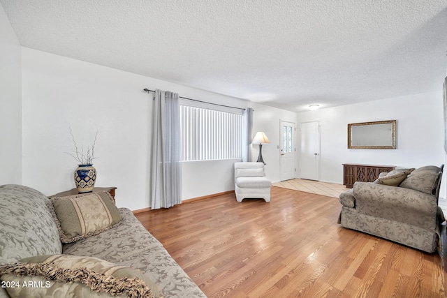 living room with hardwood / wood-style flooring and a textured ceiling