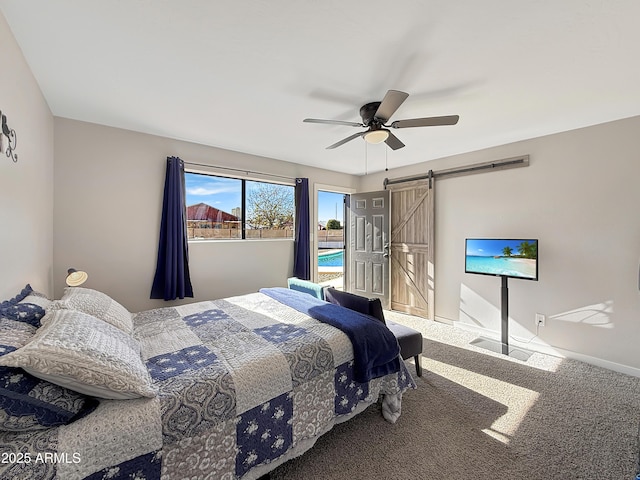 bedroom with carpet floors, a barn door, and ceiling fan