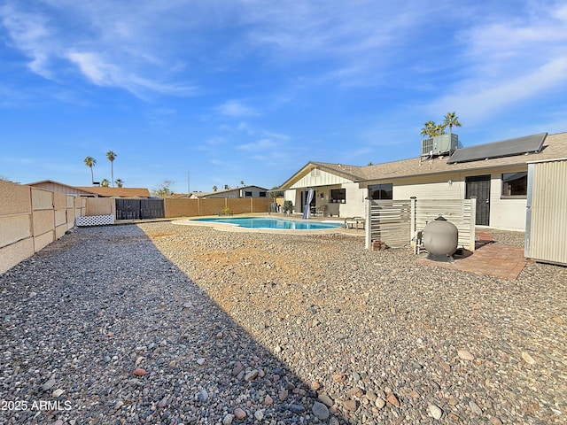 view of yard with cooling unit, a fenced in pool, and a patio area