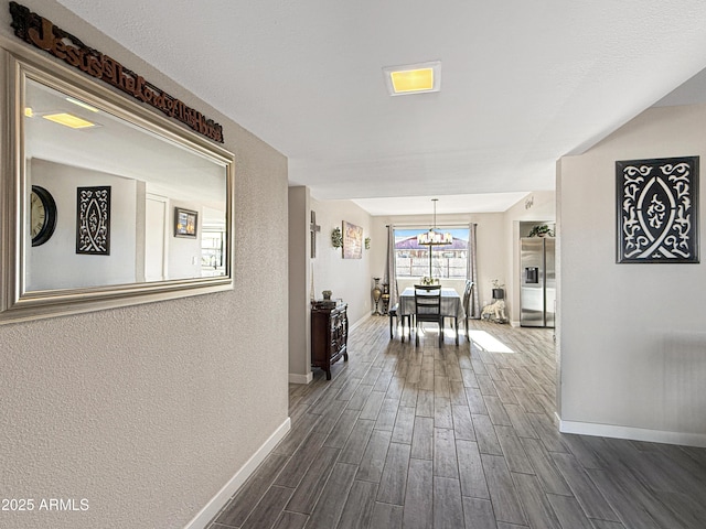 corridor featuring an inviting chandelier