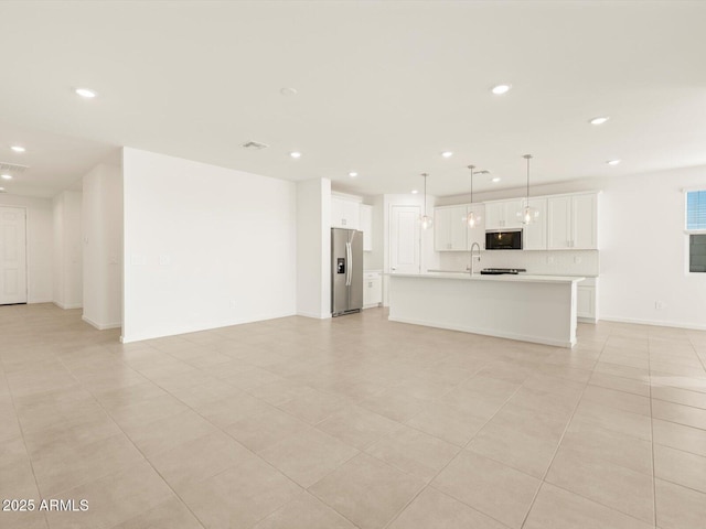 unfurnished living room with sink and light tile patterned floors