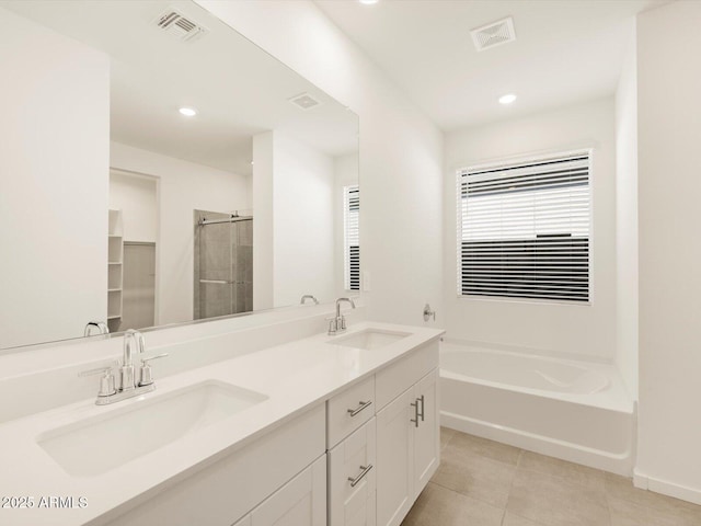 bathroom with tile patterned flooring, vanity, and independent shower and bath