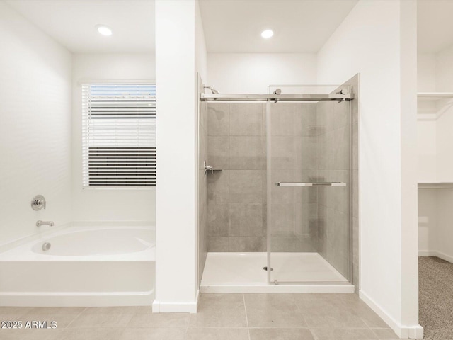 bathroom featuring independent shower and bath and tile patterned flooring