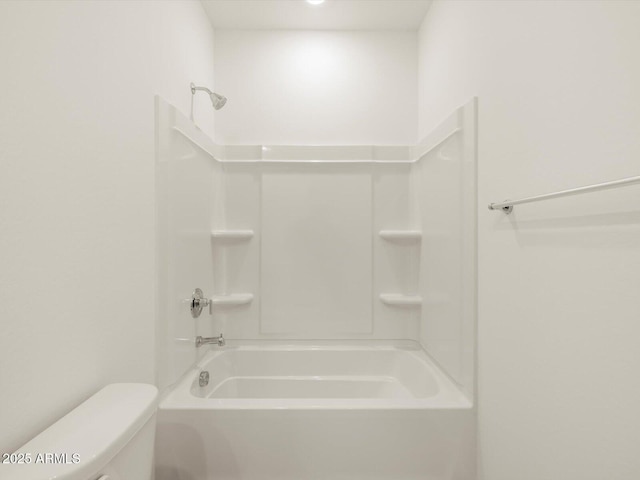 bathroom featuring tub / shower combination and toilet