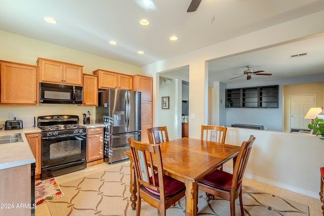 kitchen with light brown cabinetry, sink, ceiling fan, and black appliances