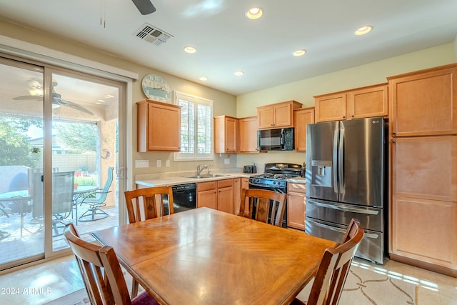 kitchen with black appliances, ceiling fan, and sink