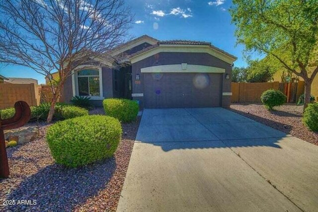 6731 S 37th Dr, Phoenix, AZ 85041 - view of front of house with driveway, an attached garage, and stucco siding