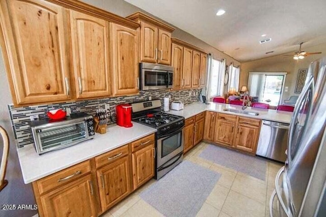 6731 S 37th Dr, Phoenix, AZ 85041 - kitchen with appliances with stainless steel finishes, tasteful backsplash, ceiling fan, light countertops, and recessed lighting