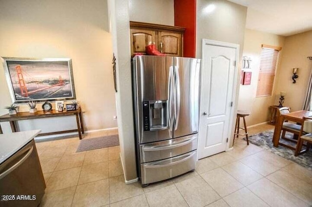 6731 S 37th Dr, Phoenix, AZ 85041 - kitchen with stainless steel fridge, light tile patterned floors, and light countertops