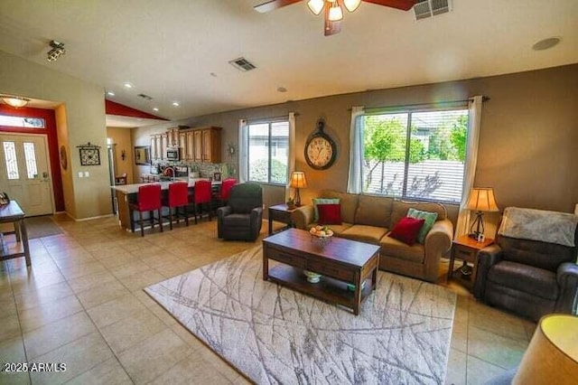 6731 S 37th Dr, Phoenix, AZ 85041 - living room with a ceiling fan, light tile patterned floors, and lofted ceiling