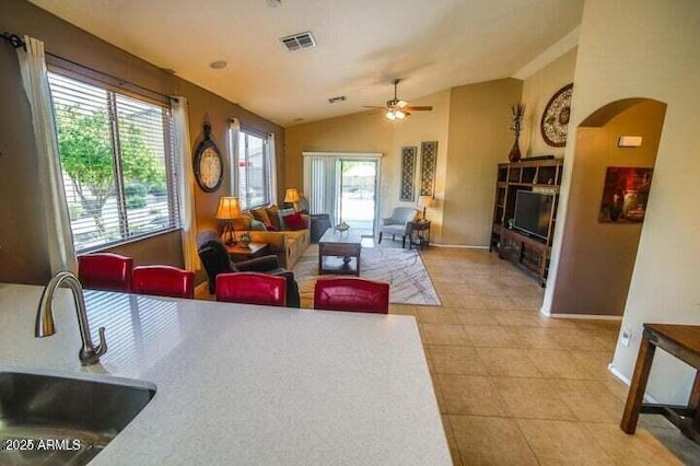 6731 S 37th Dr, Phoenix, AZ 85041 - living room featuring arched walkways, vaulted ceiling, and a ceiling fan