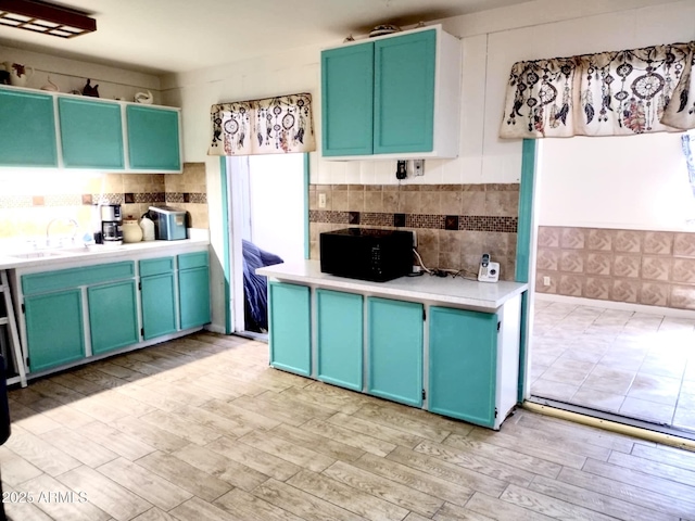 111 W 9th St, Ajo, AZ 85321 - kitchen featuring a sink, blue cabinets, and light wood finished floors