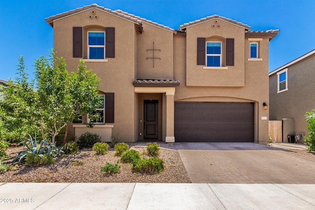 9837 E Satellite Dr, Mesa, AZ 85212 - mediterranean / spanish-style house featuring a tiled roof, stucco siding, an attached garage, and decorative driveway