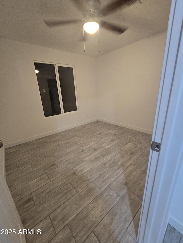 unfurnished room with hardwood / wood-style flooring and ceiling fan