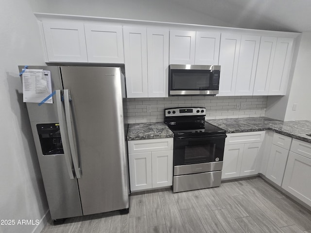 kitchen featuring backsplash, white cabinets, and stainless steel appliances