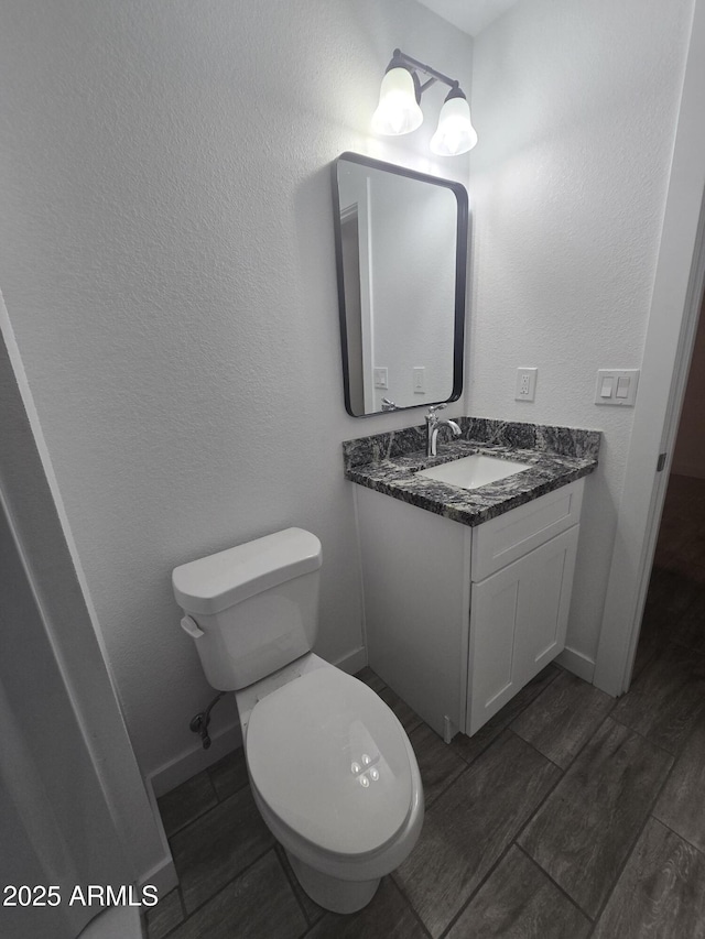 bathroom with toilet and vanity