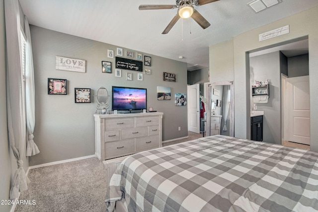 carpeted bedroom with visible vents, baseboards, and ceiling fan