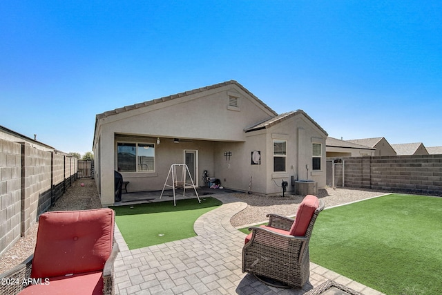 back of property with a patio, central air condition unit, a fenced backyard, and stucco siding